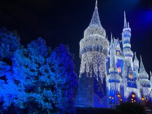 Iconic Cinderella Castle Dream Lights holiday display at Magic Kingdom