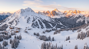 Aerial view of Sunshine Village ski resort with Goat's Eye Mountain covered in fresh powder during golden hour